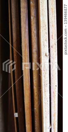 Timber boards arranged in a repair setting with visible wear and natural patterns. Suitable for construction backgrounds, material textures, and woodworking visuals. Timber boards arranged in a repair setting with visible wear and natural patterns. Suitable for construction backgrounds, material textures, and woodworking visuals. 139466877