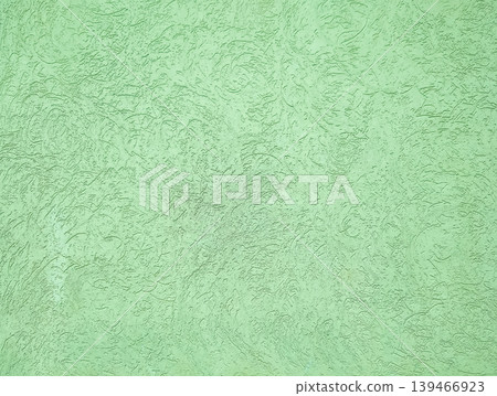 Soft green textured concrete wall with distressed and weathered finish. Can be used as a background for urban design, branding, and digital artwork. Soft green textured concrete wall with distressed and weathered finish. Can be used as a background for urban design, branding, and digital artwork. 139466923