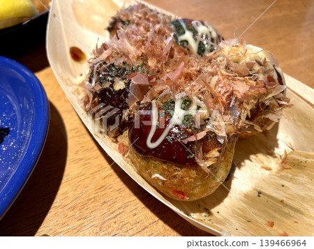 Takoyaki: Sauce, mayonnaise, bonito flakes, and dried seaweed. Takoyaki: Sauce, mayonnaise, bonito flakes, and dried seaweed. 139466964
