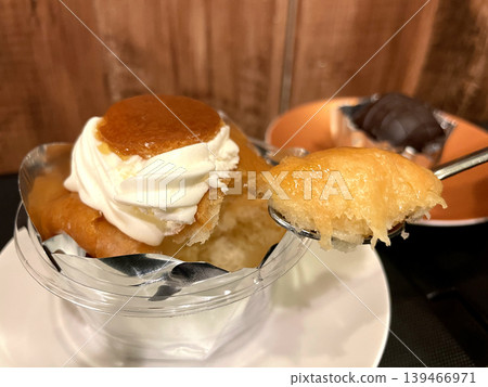 Savarin soaked in syrup, topped with whipped cream. Savarin soaked in syrup, topped with whipped cream. 139466971