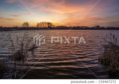Sunset over a calm lake 139467272