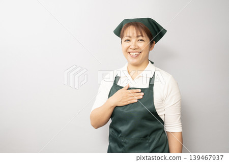 A woman putting her hand on her chest 139467937