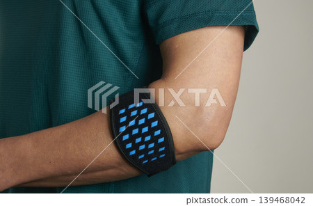 an epicondylitis brace worn by a sportsman an epicondylitis brace worn by a sportsman 139468042