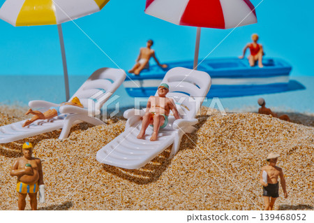miniature people enjoying a day on the beach miniature people enjoying a day on the beach 139468052