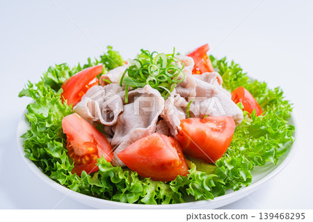 Pork shabu-shabu salad, a refreshing cold shabu-shabu salad with lettuce and tomatoes, white background. Pork shabu-shabu salad, a refreshing cold shabu-shabu salad with lettuce and tomatoes, white background. 139468295