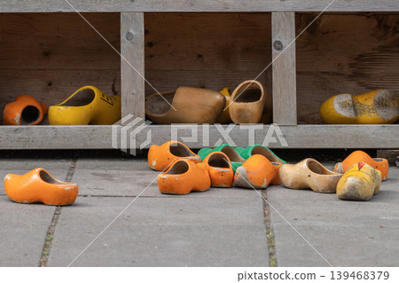 Vintage Dutch Wooden Clogs on Rustic Wooden Shelves 139468379