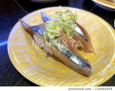 Raw Pacific saury nigiri sushi topped with green onions Raw Pacific saury nigiri sushi topped with green onions 139468404