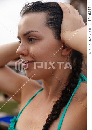 Pretty woman touching braided hair with glowing radiant healthy facial skin outdoors gracefully today. Pretty model showing smooth fresh complexion texture during tropical beauty vacation beside Pretty woman touching braided hair with glowing radiant healthy facial skin outdoors gracefully today. Pretty model showing smooth fresh complexion texture during tropical beauty vacation beside 139468434