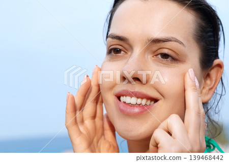Pretty woman touching radiant facial skin with glowing healthy smooth complexion outdoors gracefully today. Pretty model showing fresh beauty texture during skincare routine beside tropical seaside Pretty woman touching radiant facial skin with glowing healthy smooth complexion outdoors gracefully today. Pretty model showing fresh beauty texture during skincare routine beside tropical seaside 139468442