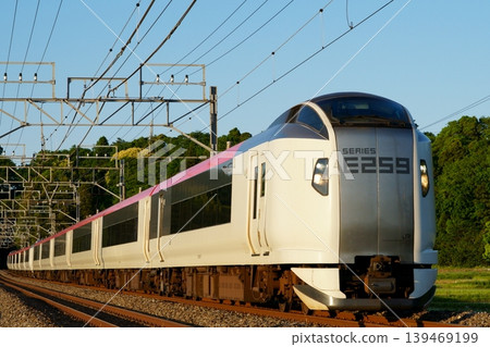 The Narita Express travels through the soft setting sun. The Narita Express travels through the soft setting sun. 139469199