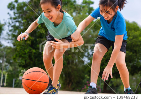 Active students practicing basketball drills during physical education class or after school sports program. 139469238