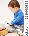 Baby, guitar toys and play in home for entertainment joy, childhood development or education. Boy, kid and instruments for musical strings for song learning in apartment or growing, progress or games 139469631