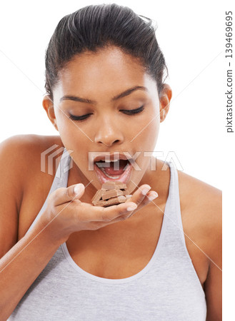 Diet, sweets and woman with chocolate, eating and wellness isolated on a white studio background. Cocoa, person and model with fitness, candy and unhealthy snack with mockup space, hungry and food Diet, sweets and woman with chocolate, eating and wellness isolated on a white studio background. Cocoa, person and model with fitness, candy and unhealthy snack with mockup space, hungry and food 139469695