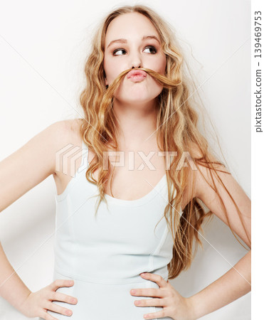 Funny, woman and mustache with hair and fashion, style or confidence in white background or studio. Crazy, humor and model with formal and trendy outfit or silly pose with hairstyle for comedy Funny, woman and mustache with hair and fashion, style or confidence in white background or studio. Crazy, humor and model with formal and trendy outfit or silly pose with hairstyle for comedy 139469753