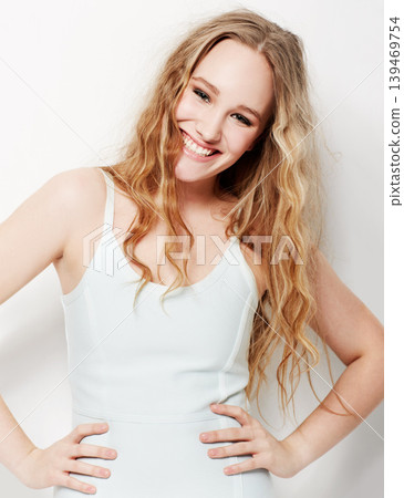 Fashion, style and confident portrait of woman with a smile in white background of studio. Happy, model and hands on hips with pride in formal, trendy outfit and lady with beauty and joy on backdrop Fashion, style and confident portrait of woman with a smile in white background of studio. Happy, model and hands on hips with pride in formal, trendy outfit and lady with beauty and joy on backdrop 139469754