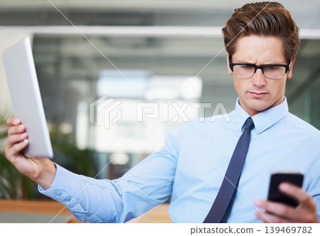 Businessman, tablet and confusion for smartphone in office, website and mobile application on tech. Male person, communication and typing a message or texting, online research and doubt or question Businessman, tablet and confusion for smartphone in office, website and mobile application on tech. Male person, communication and typing a message or texting, online research and doubt or question 139469782