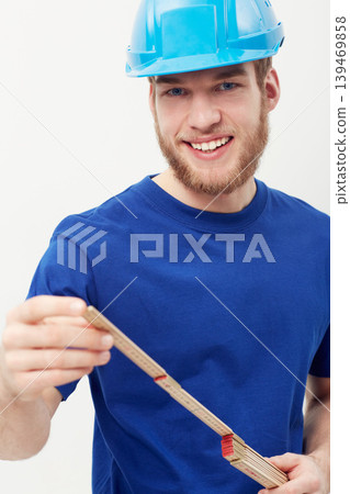 Portrait, builder and man with a hard hat, measurement tape and smile isolated on a white studio background. Face, person and construction worker with a helmet, safety and equipment with entrepreneur 139469858