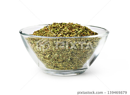 Dried oregano filling glass bowl on white background 139469879