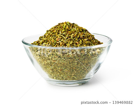 Dry oregano herbs in glass bowl on white Dry oregano herbs in glass bowl on white 139469882