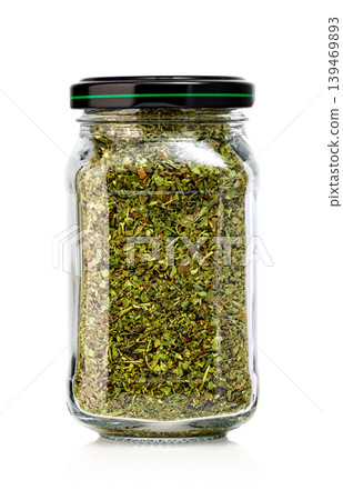 Dried oregano glass jar on white background Dried oregano glass jar on white background 139469893