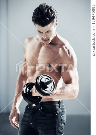 Sports, muscles and man with dumbbell weight in a studio for bodybuilding workout, exercise or training. Fitness, health and young male athlete from Canada with equipment isolated by gray background. Sports, muscles and man with dumbbell weight in a studio for bodybuilding workout, exercise or training. Fitness, health and young male athlete from Canada with equipment isolated by gray background. 139470093