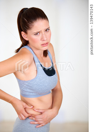 Pinch, stomach and portrait of woman for fitness, exercise and workout to lose weight. Worry, sad and person holding skin or body fat for diet, liposuction and tummy tuck for wellness or health Pinch, stomach and portrait of woman for fitness, exercise and workout to lose weight. Worry, sad and person holding skin or body fat for diet, liposuction and tummy tuck for wellness or health 139470143