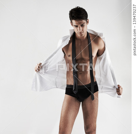 Body, man and underwear with shirt and tie in white background and studio. Muscular, formal and model with six pack undressing with sensual fitness, health and wellness in aesthetic mock up space Body, man and underwear with shirt and tie in white background and studio. Muscular, formal and model with six pack undressing with sensual fitness, health and wellness in aesthetic mock up space 139470237