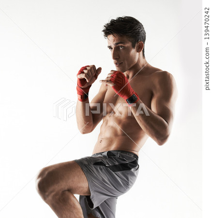 Man, kick boxer and strong in gym, serious and face for workout, boxing or white background. Exercise, sports and training for power, self defense and concentrate for challenge, mma or fight skills Man, kick boxer and strong in gym, serious and face for workout, boxing or white background. Exercise, sports and training for power, self defense and concentrate for challenge, mma or fight skills 139470242