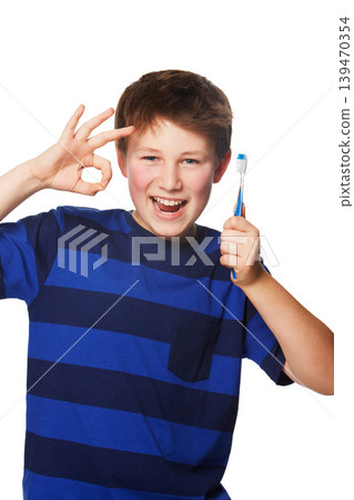 Toothbrush, portrait or child with perfect hand in studio for dental, care or feedback on white background. Teeth, cleaning or boy kid face with OK, yes or success emoji for oral hygiene or wellness Toothbrush, portrait or child with perfect hand in studio for dental, care or feedback on white background. Teeth, cleaning or boy kid face with OK, yes or success emoji for oral hygiene or wellness 139470354