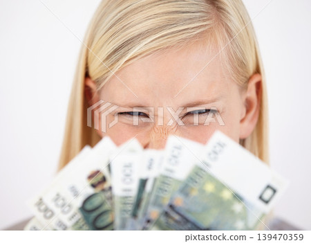 Money, finance and lottery winner with a woman closeup in studio on a white background for profit or increase. Eyes, economy or investment and an excited young person with cash for financial freedom Money, finance and lottery winner with a woman closeup in studio on a white background for profit or increase. Eyes, economy or investment and an excited young person with cash for financial freedom 139470359