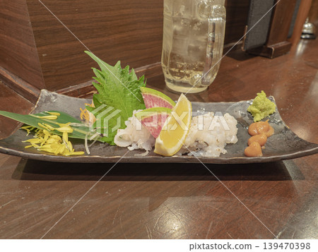 A refreshing treat. A master chef showcases seared conger eel sashimi. A refreshing treat. A master chef showcases seared conger eel sashimi. 139470398