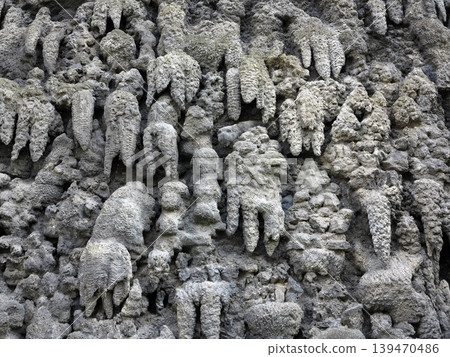 Close-Up of Artificial Stalactite Formations and Textured Rock Surface in Gray Wall Close-Up of Artificial Stalactite Formations and Textured Rock Surface in Gray Wall 139470486