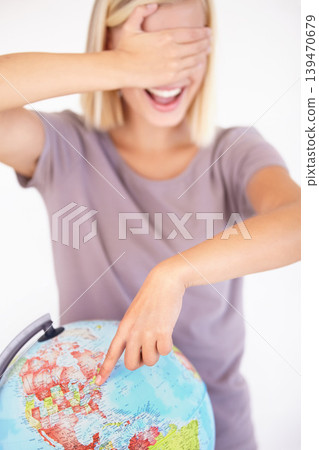 Globe, hand and pointing with a woman tourist in studio on a white background for travel destination choice. World, atlas or random selection and a person covering her eyes for location decision Globe, hand and pointing with a woman tourist in studio on a white background for travel destination choice. World, atlas or random selection and a person covering her eyes for location decision 139470679