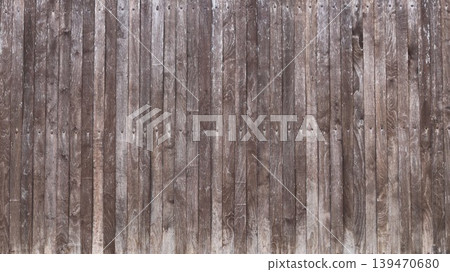 Beautiful old textured rustic fence made of narrow wooden planks with nail heads in the joint structure, gray plank solid fence made of natural aged wood as a country style background texture Beautiful old textured rustic fence made of narrow wooden planks with nail heads in the joint structure, gray plank solid fence made of natural aged wood as a country style background texture 139470680