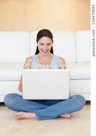 Happy woman, laptop and typing for social media, communication or networking on floor at home. Female person, writer or freelancer smile on computer for online research, browsing or email at house 139470685