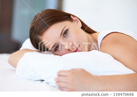 Portrait, pillow and bedroom with a woman resting and home with weekend break, awake and wellness. Face, person and apartment with girl, relax and peace with freedom, cushion and blanket with health 139470698