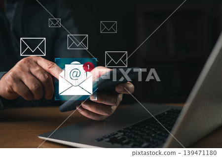 Businessman checking new email notification on smartphone with laptop on desk, concept of digital communication, online messaging, email marketing, and modern business connection. Businessman checking new email notification on smartphone with laptop on desk, concept of digital communication, online messaging, email marketing, and modern business connection. 139471180