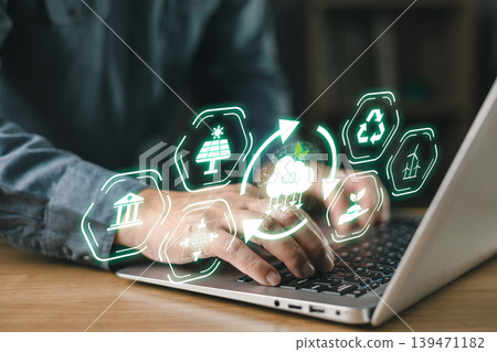 Person typing on laptop with floating eco icons, symbolizing sustainability, renewable energy, carbon reduction, green technology, and environmental responsibility in digital innovation.climate change Person typing on laptop with floating eco icons, symbolizing sustainability, renewable energy, carbon reduction, green technology, and environmental responsibility in digital innovation.climate change 139471182