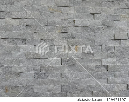 Stone brick wall texture creating rough gray background with unique pattern Stone brick wall texture creating rough gray background with unique pattern 139471197
