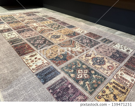 Ornate patterned rug with colorful geometric design on wooden floor background Ornate patterned rug with colorful geometric design on wooden floor background 139471231