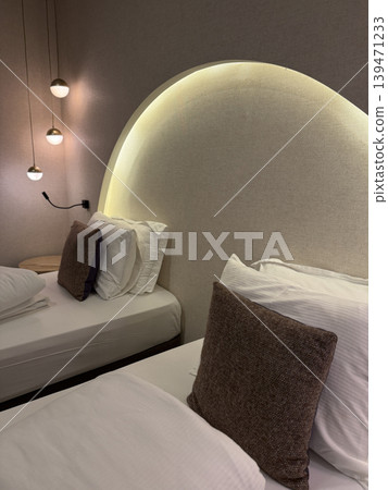 Modern hotel room interior with stylish lighting and cozy bedding, perfect for relaxation background Modern hotel room interior with stylish lighting and cozy bedding, perfect for relaxation background 139471233