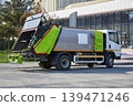 New garbage truck parked street. Modern waste management vehicle for trash collection and city cleaning service. Industrial equipment for municipal sanitation and environmental maintenance. 139471246