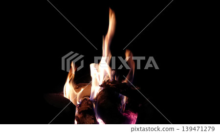 The hot embers of burning wood log fire isolated on black. Firewood burning on stove. 139471279