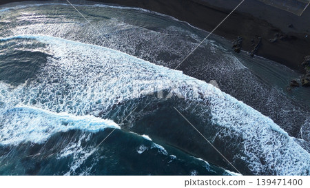 Expansive sea with jagged rocks and foaming surf under cloudy sky. Spectacular drone capture of turquoise waters meeting rugged coastline with wave crashes under windy weather Expansive sea with jagged rocks and foaming surf under cloudy sky. Spectacular drone capture of turquoise waters meeting rugged coastline with wave crashes under windy weather 139471400