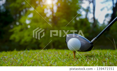 Golf clubs and balls on a green lawn in a beautiful golf course with morning sunshine. Golf clubs and balls on a green lawn in a beautiful golf course with morning sunshine. 139471551