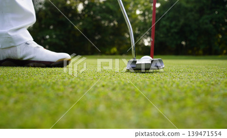Golfers are putting golf in the evening golf course golf backglound. Golfers are putting golf in the evening golf course golf backglound. 139471554