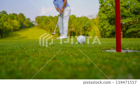 Golfers are putting golf in the evening golf course golf backglound. 139471557
