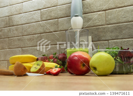 Preparing a healthy green smoothie with fresh fruits Preparing a healthy green smoothie with fresh fruits 139471611