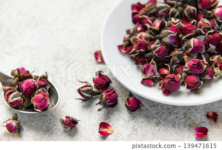 Dried rose buds creating floral herbal tea mix Dried rose buds creating floral herbal tea mix 139471615
