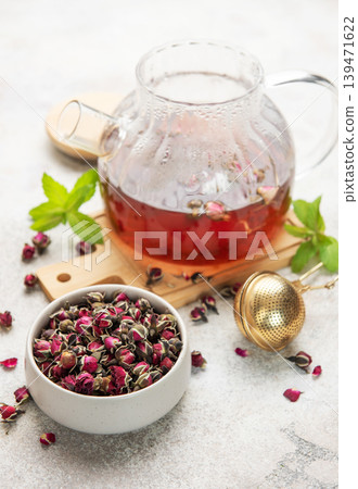 Rose petal tea brewing in glass teapot with mint Rose petal tea brewing in glass teapot with mint 139471622